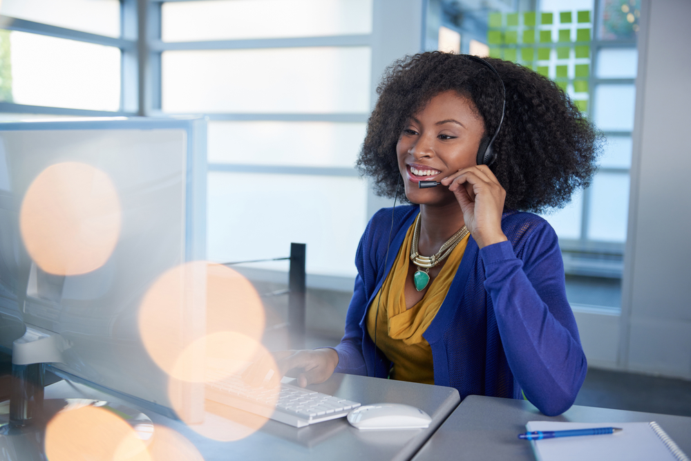 Person using a headset while on the computer conducting an interview.