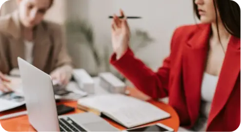 Woman sitting at laptop writing a review. 