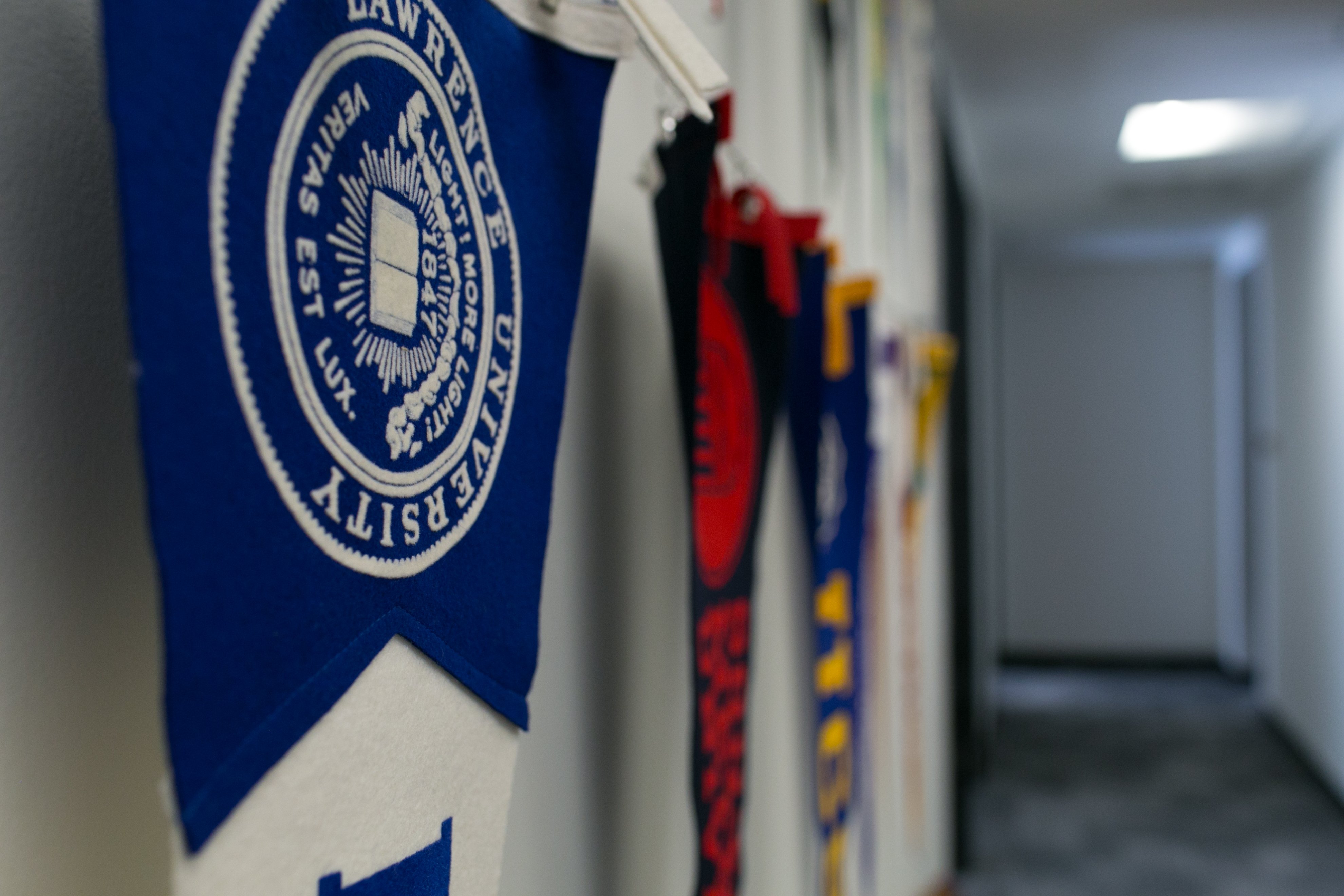 College pennant flags hung from wall.