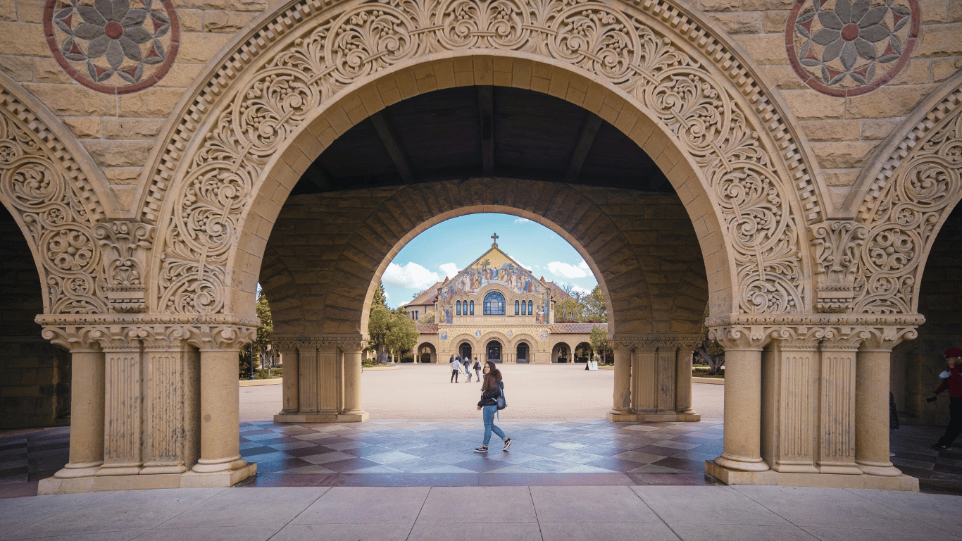 Woman walking through Stanford University's campus square.
